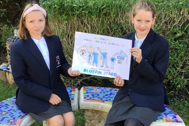 Durrington Infant and Junior Federated Schools' head girls with the school’s twinning ward poster