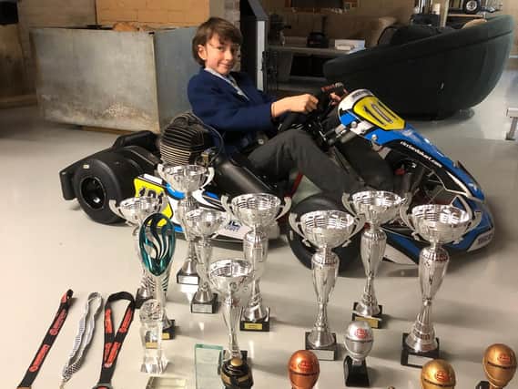 Jamie Warner with his kart and trophies