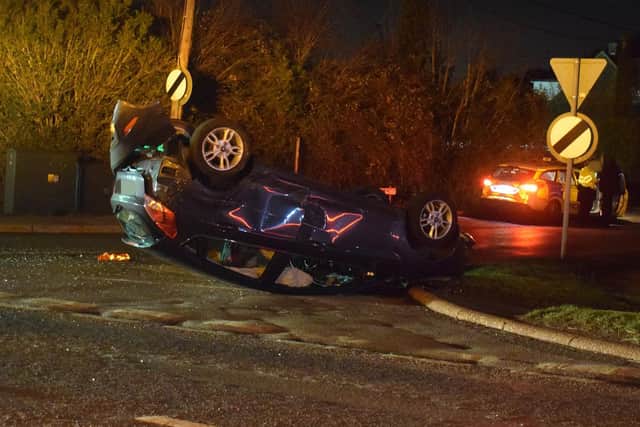 A car was left badly damaged after flipping onto its roof. Photo: Dan Jessup