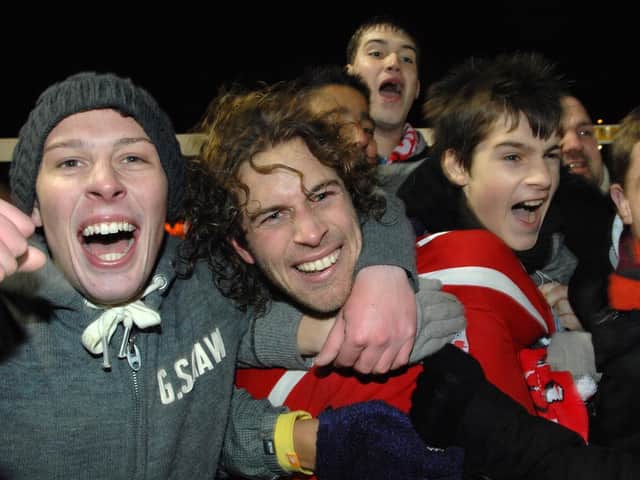 Crawley Town fans on the pitch with Sergio Torres after he scored the winner against Derby County. Picture by Jon Rigby