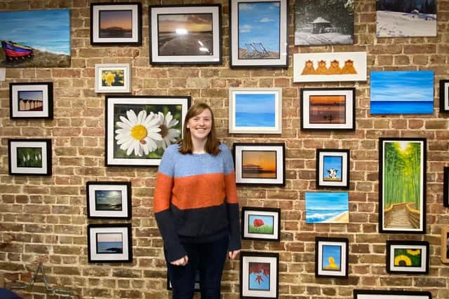 Imogen Marshall with her first solo exhibition, at Pier Road Coffee and Art in Littlehampton