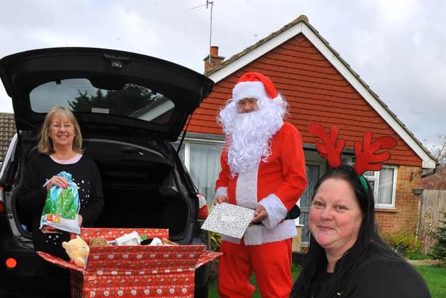 'Father Christmas' with Chrissie Blackman, Natasha Lavender and the donated gifts