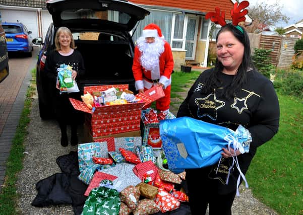 'Father Christmas' with Chrissie Blackman, Natasha Lavender and the donated gifts