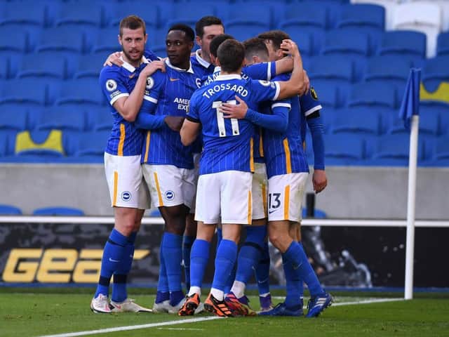 Adam Webster and Brighton celebrate Pascal Gross' last minute penalty against Liverpool