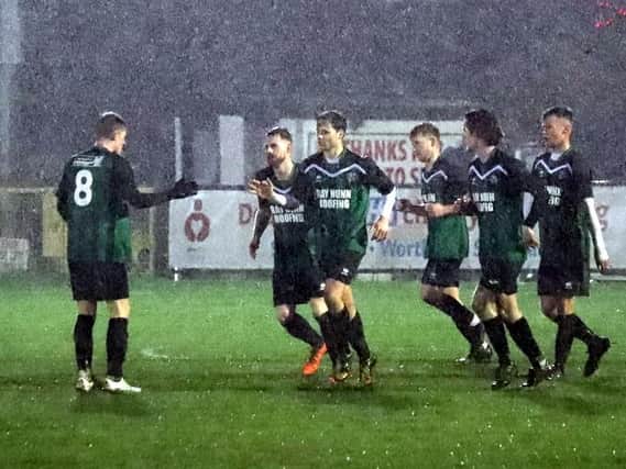 Pagham celebrate the game's only goal / Picture: Roger Smith