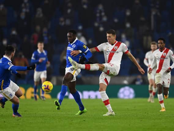 Danny Welbeck is tackled by Jan Bednarek during the Premier League match between Brighton & Hove Albion and Southampton at American Express Community Stadium.. (Photo by Mike Hewitt/Getty Images)