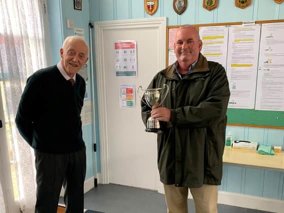 Marine Gardens BC captain Michael Ives presents the Merit Cup to Terry Urben