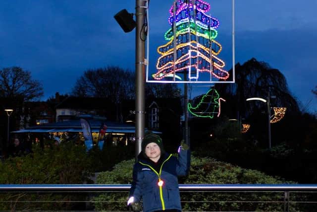 Harry Botting with the Christmas light he designed. Photo: Visit Horsham