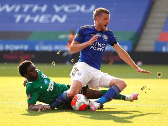 Brighton's Tariq Lamptey and Leicester Jamie Vardy tussle for possession