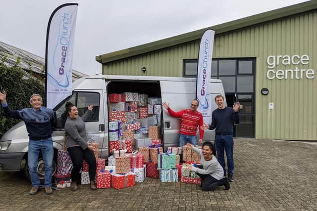 David Thompson, in the red Christmas jumper, and the Grace Church loading team celebrate a full van of gifts