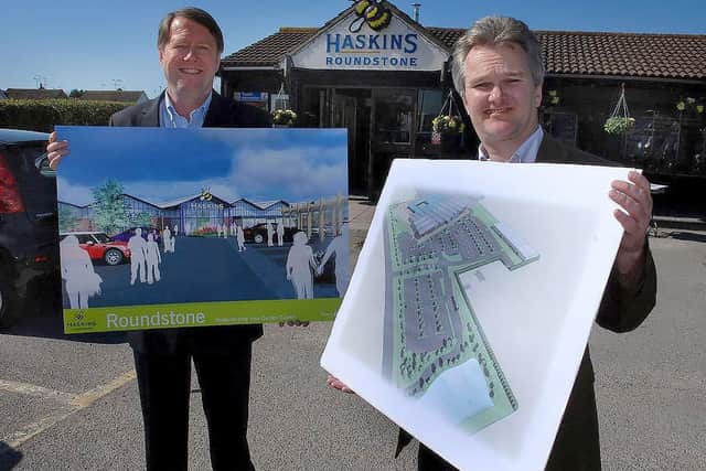 Haskins Garden Centres chairman Warren Haskins and chief executive Julian Winfield in front of the old entrance to the Roundstone garden centre, with the plans for the £13million redevelopment