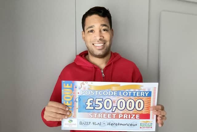 Danyl Johnson with one of the winning cheques SUS-201229-125748001
