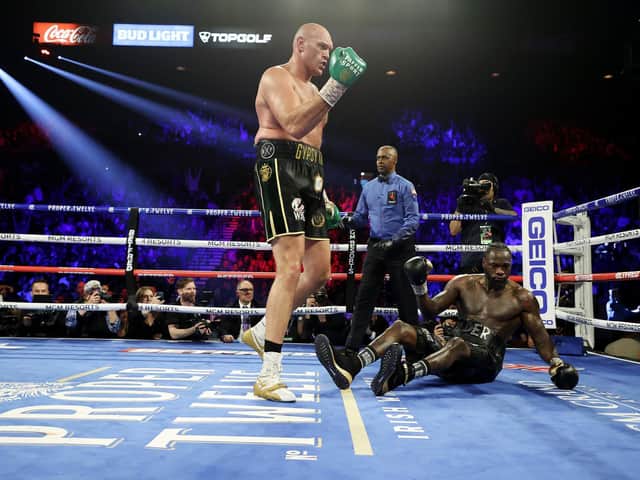 Tyson Fury knocks  down Deontay Wilder