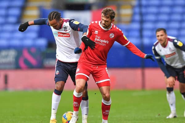 Jack Powell battles with Nathan Delfouneso at Bolton
