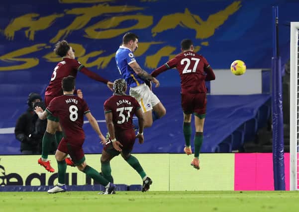 Lewis Dunk of Brighton & Hove Albion scores their team's third goal during the Premier League match between Brighton & Hove Albion and Wolverhampton Wanderers at American Express Community Stadium on January 02, 2021. (Photo by Gareth Fuller - Pool/Getty Images)