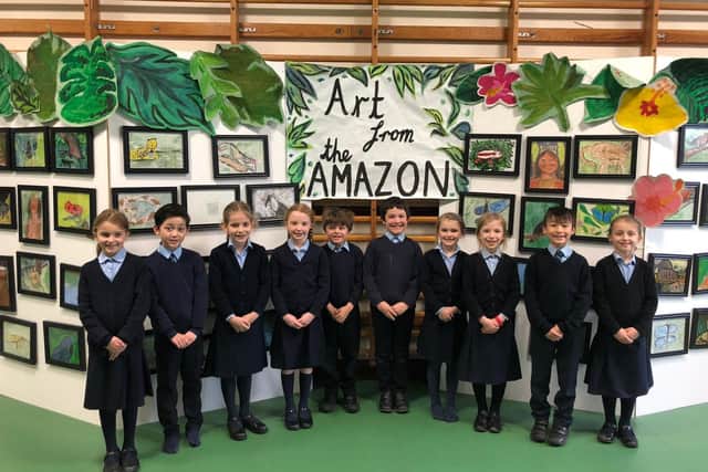 Year three pupils from St Ives School with their Amazon artwork