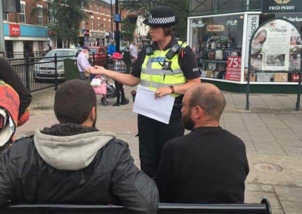 A police officer speaking to street drinkers