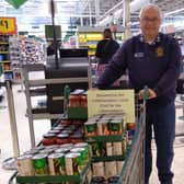 President David Bishop with a trolley load of groceries purchased by Littlehampton District Lions Club for Littlehampton & District Foodbank