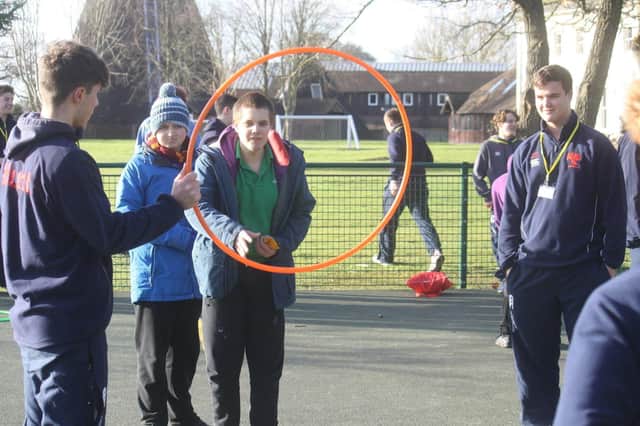 An LVS Hassocks student engages with Hurstpierpoint College sports leaders during a games session SUS-200220-130237001
