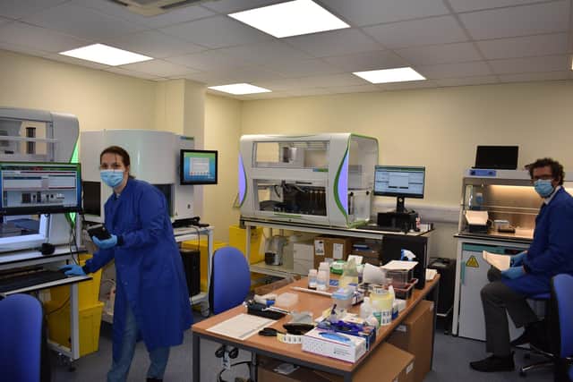 Pathology staff working with the new Covid testing machines SUS-210114-130230001