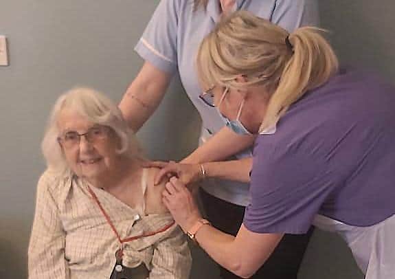 Walberton Place Care Home resident Dot Woosnam receives her first dose of the Oxford Astra-Zeneca vaccine from Avisford Medical Group's paramedic practitioner Ronnie Redstone tm4-U1U29ub_Wa3KZole