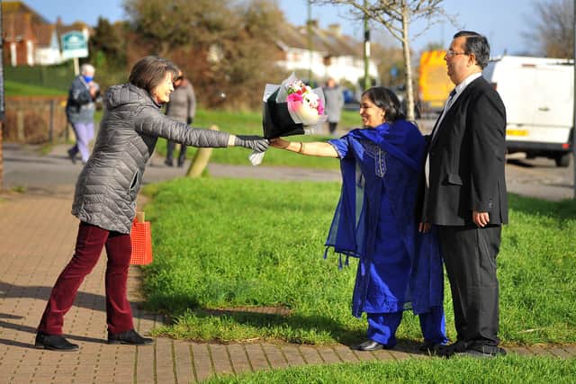 Penny Joseph from St Giles' Church presenting flowers to Ashok and Shobha Sthankiya at Southlands Post Office. Picture: Steve Robards SR2101231