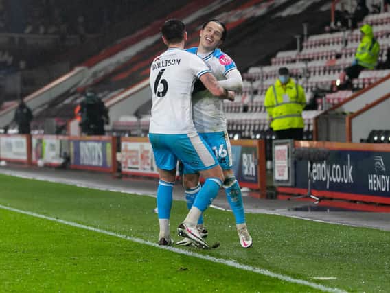 Tom Dallison is first too celebrate with goalscorer Tom Nichols. Picture by UK Sports Images Ltd