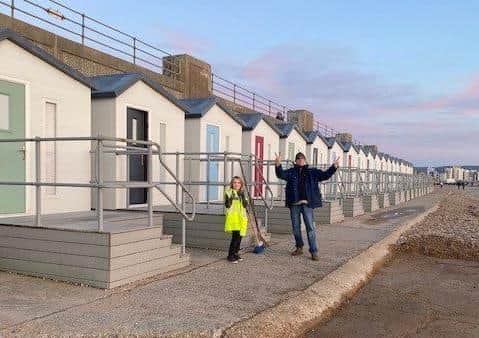 Steven and Carolyn Sparks from the Facebook group, Seaford Beach Hut Society, cleared shingle from Seaford promenade with their eight-year-old son