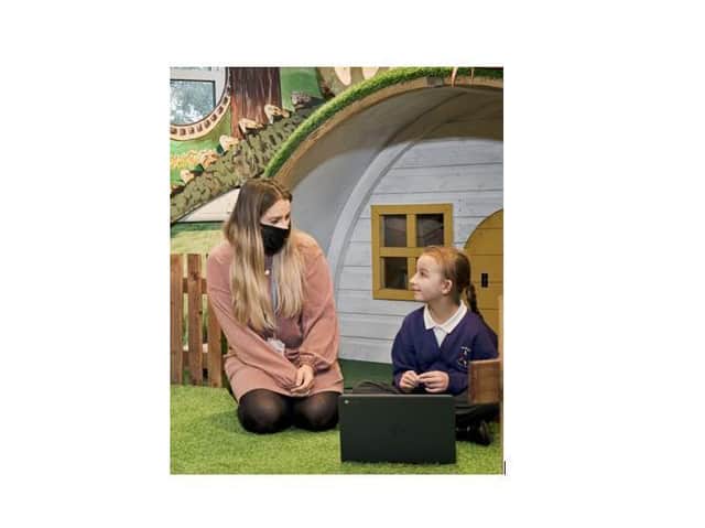 Poppy Marples & a Portfield Primary Academy pupil receiving a Young Carers Connect laptop. Photo Sarah Sheldrake