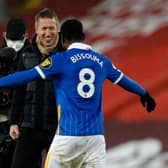Graham otter celebrates victory at Anfield with his star midfielder Yves Bissouma
