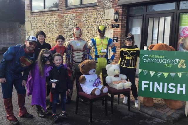 Derren Piner and his fellow superheroes outside The Sussex Snowdrop Trust in Walberton