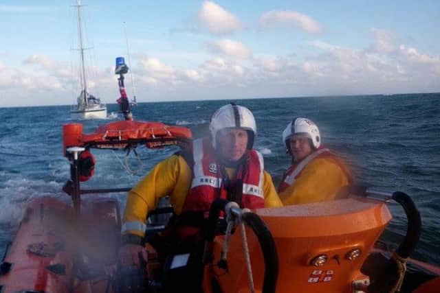 Andy Harris at the helm of the Blue Peter 1, towing a yacht back to harbour in June 2012. Picture: RNLI
