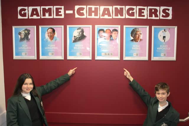 Year-seven students Dulcie Balmer and Harvey Metcalfe with one of the Game-Changers displays, show examples from around the world