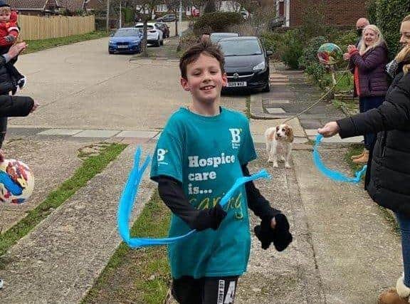 Harrison Lillywhite reaches the finish line after running 50k in memory of his grandad