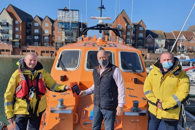 Michael Harris from the Sussex Masonic Charitable Foundation, lifeboat coxswain Mark Sawyer and Carl Pocock, Eastbourne's lifeboat operations manager SUS-210203-124945001