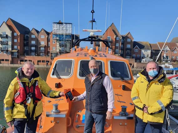 Michael Harris from the Sussex Masonic Charitable Foundation, lifeboat coxswain Mark Sawyer and Carl Pocock, Eastbourne's lifeboat operations manager SUS-210203-124945001