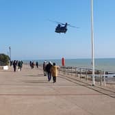 The Chinook flying over Bexhill seafront SUS-210403-103344001