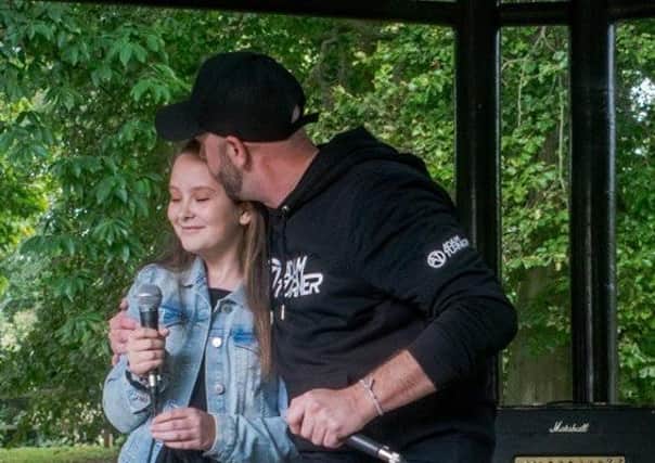 Adam Turner and his daughter after performing on stage at Bognorphenia's Big Weekend