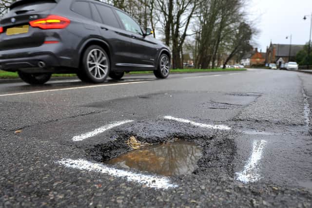 The Government has been criticised for cutting the size of the national pot of money it is giving councils for road repairs