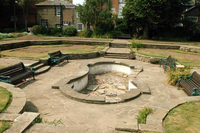 The damaged fish pond and bare flower borders in Denton Gardens in 2006