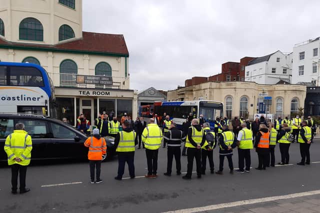 Staff at Stagecoach South's Worthing depot stand in tribute as the funeral party for Mark White passes through