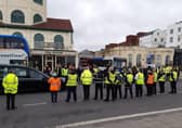 Staff at Stagecoach South's Worthing depot stand in tribute as the funeral party for Mark White passes through