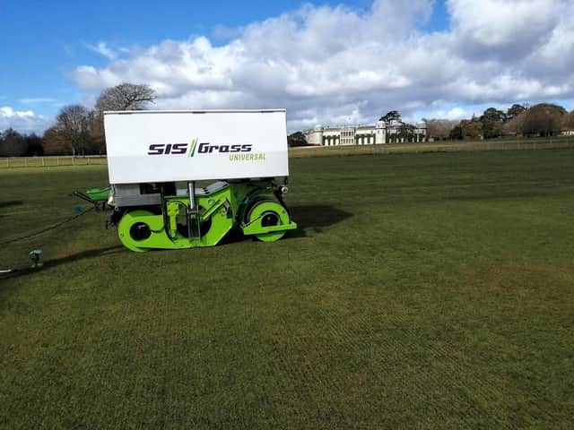 Work is carried out to install the hybrid pitches - with Goodwood House in the background