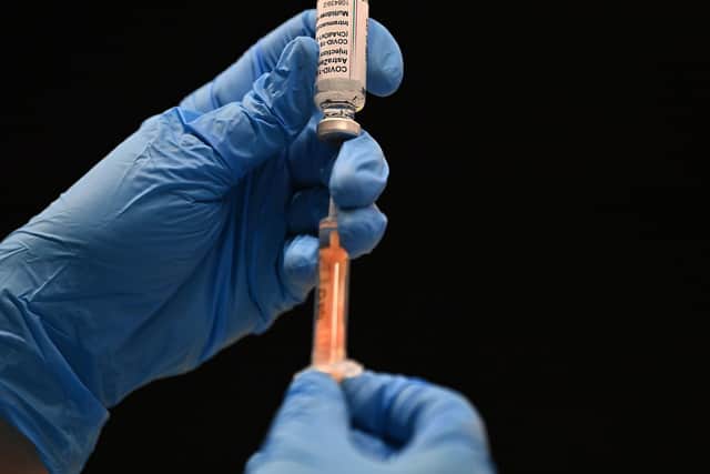 A healthcare professional draws up a dose of the Oxford/AstraZeneca Covid-19 vaccine at the vaccination centre set up inside Brighton Centre