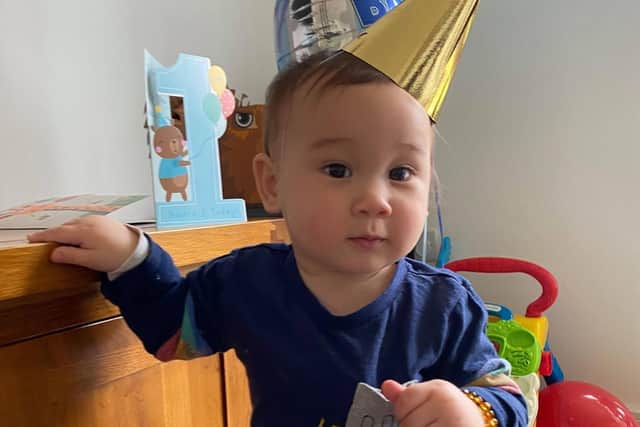 Monty Lyons wearing a party hat on his first birthday