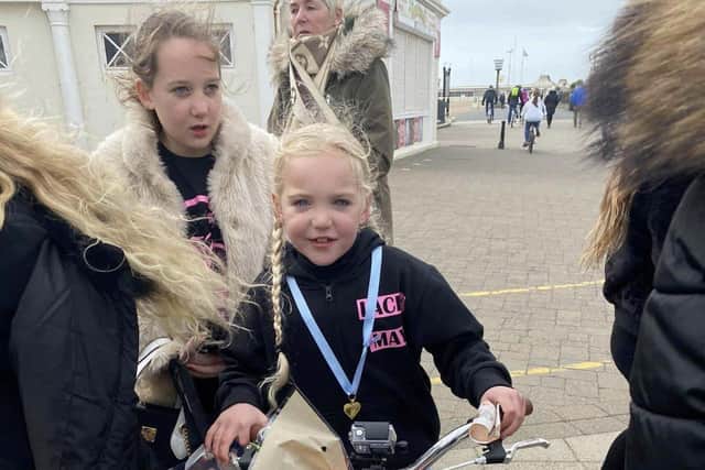 Lacey-may Hardley at Worthing Pier at the end of her ten-mile charity bike ride