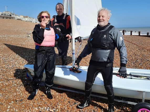 Melanie Clark, Eric Petersen and Mat Windley back on the beach and exuberant after their first sail since lockdown