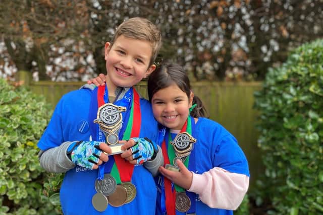 Cameron and Leah Barritt with their medals and trophies after completing their 100km charity cycle challenge