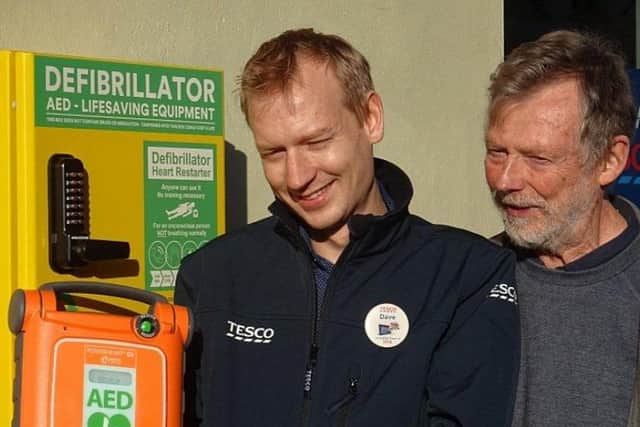 Dave Woods (Tesco Store Manager, Midhurst) and Harvey Tordoff, placing a defibrillator in North Street