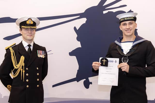 Commanding officer Captain Stuart Finn presents Naval Airman Samuel Muggeridge with his badge and certificate. Picture: Royal Navy